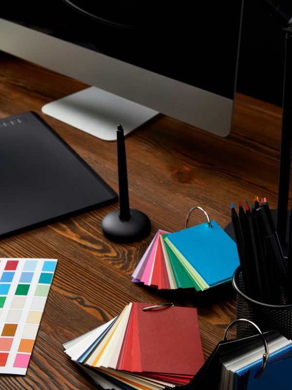 close up view of graphic designer workplace with colorful pallet, graphic tablet and computer screen